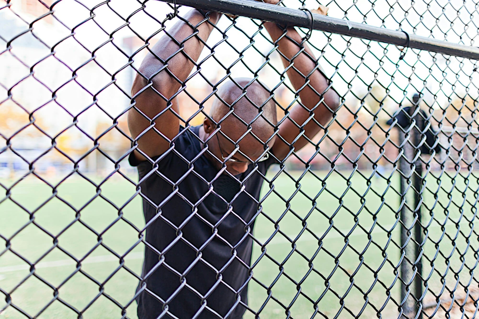 Man behind a chain link fence